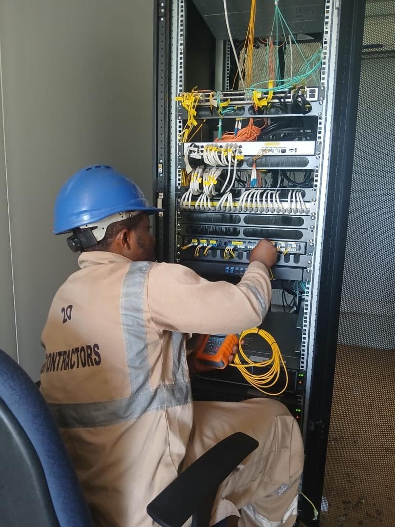 Engineer patching a fibre distribution rack